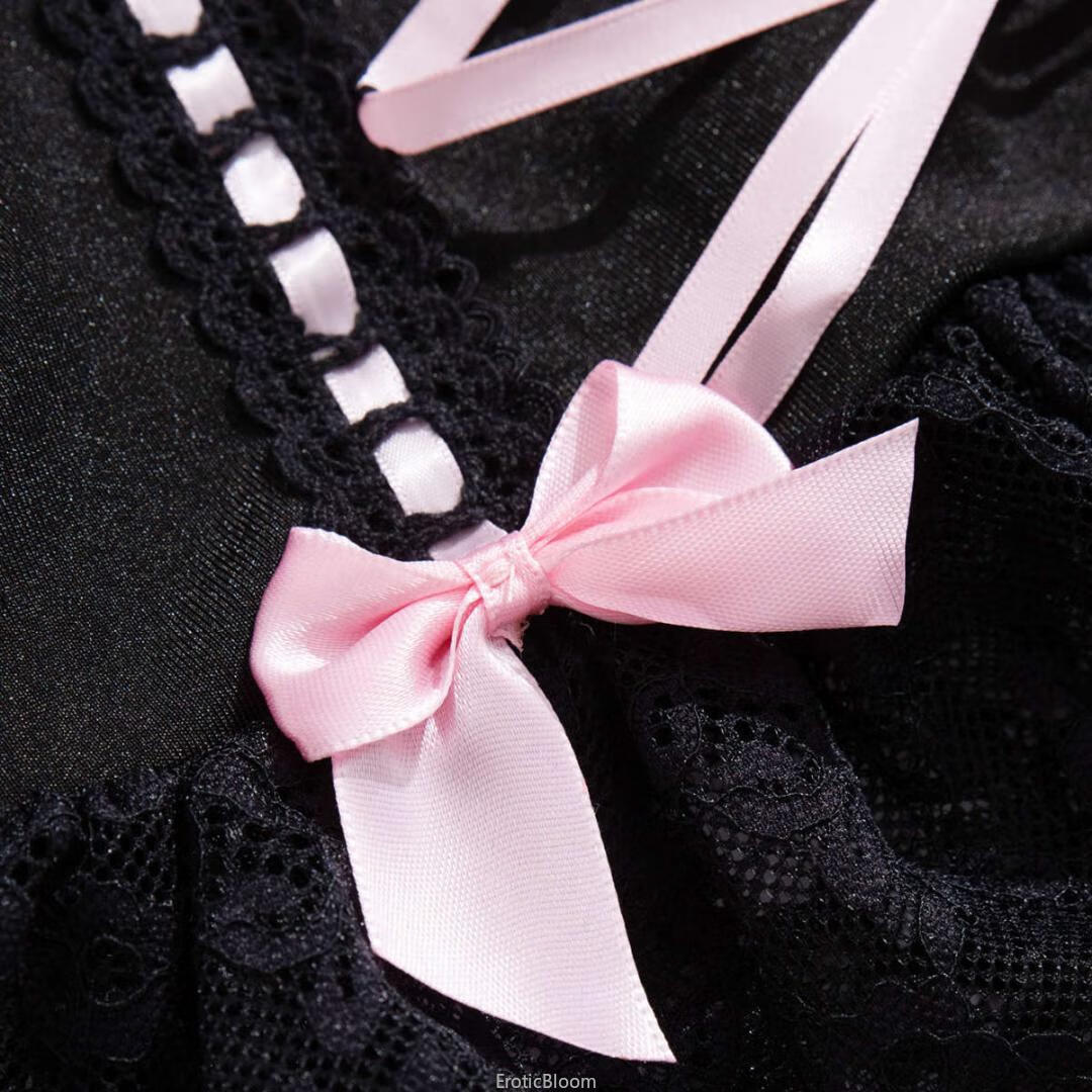 Close-up of black lace corset lingerie set with pink satin bow and ruffled skirt, showcasing French maid style and garter strap detail.