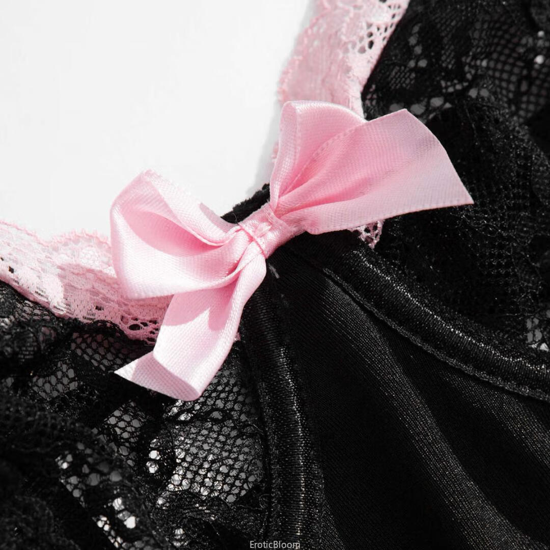 Close-up of black lace corset lingerie with pink satin bow and ruffled lace trim, part of French maid style set with garter straps.