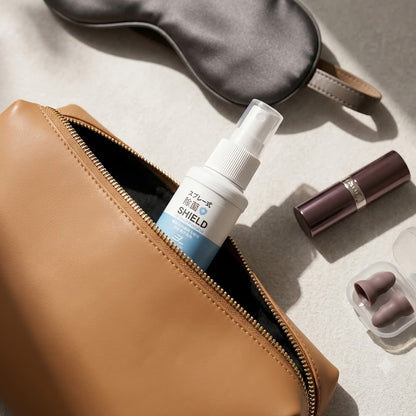 Portable Adult Toy Cleaner Tucked into a Minimalist Leather Pouch with Travel Essentials