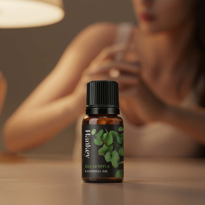 Eucalyptus essential oil bottle in the foreground, with blurred figures in the background symbolizing deep intimate connection and sensual experience.