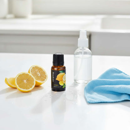 Lemon essential oil blend used for natural home cleaning, displayed with fresh lemons and a spray bottle on a clean kitchen counter.