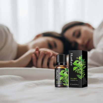 Tea Tree purifying sensual oil in the foreground, with blurred figures in the background showing pure intimate connection and comfortable freshness.